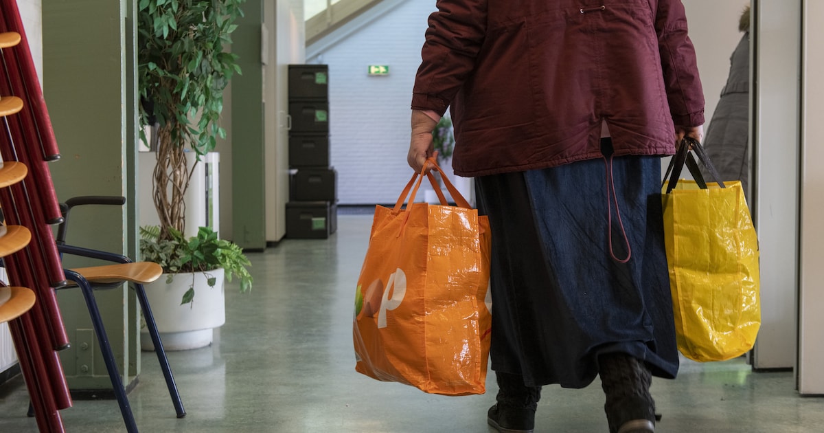 een-vrouw-verlaat-de-voedselbank-met-volle-tassen