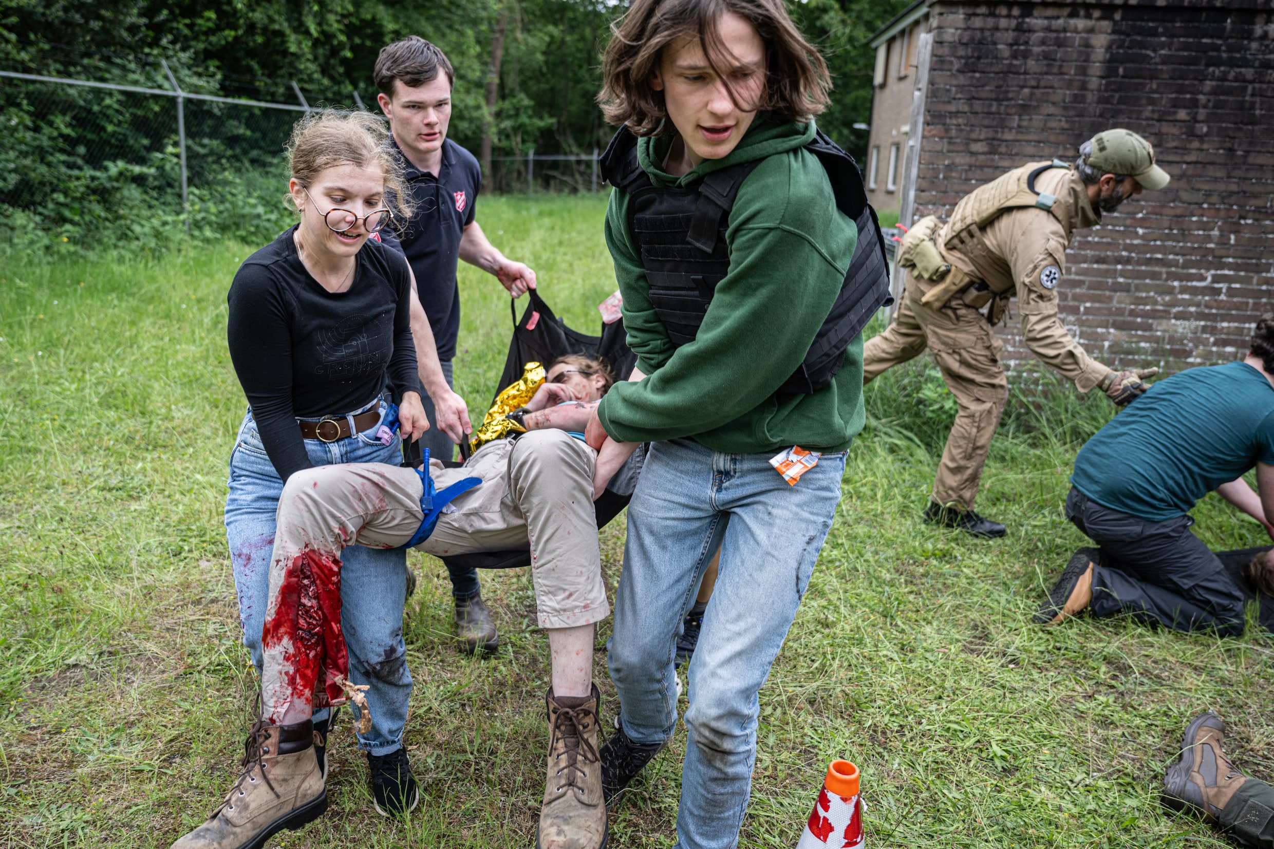 Cardioloog Lennart Bongartz (met pet) tijdens de training (met veel bloed en kermende acteurs) bij de Oranje Kazerne in Schaarsbergen.